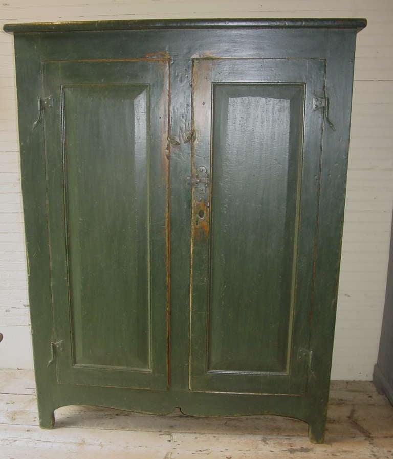 A simple green armoire from Quebec.  Paneled doors
Restored