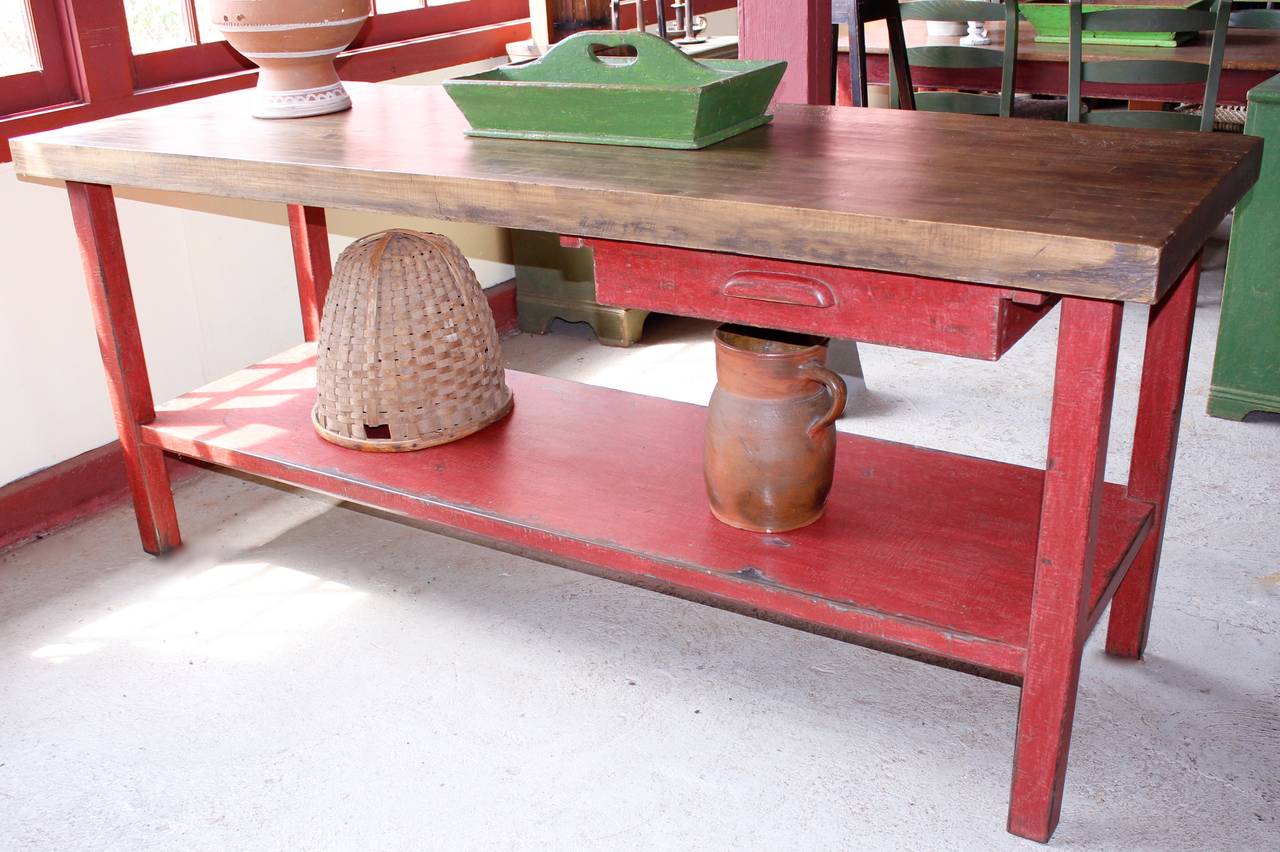 An industrial work counter / workbench found in a factory. 
There is a wooden butcher style top, the base and shelf are made of iron.
Also a double sided drawer.