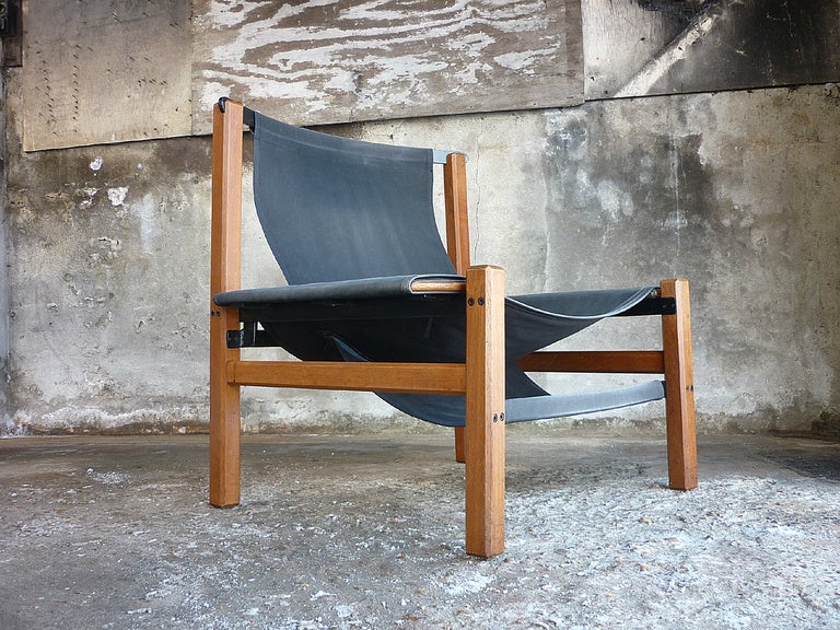 Looking for a RAW chair? This is the one! Fantastic and sober designed chair which you won't come across twice easely. The rough looking sailcloth slingseat and back are in a perfect balance with the heavy teak frame. The massive and heavy metal