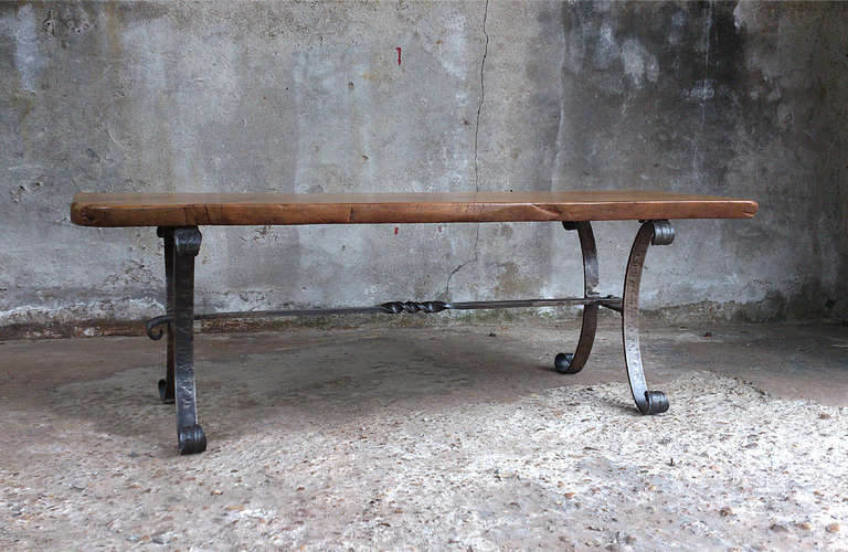 French arts & craft wrought iron coffee table. The iron base is made with the old blacksmith principals. There are no nails or screws used in the manufacturing process. The horizontal bar is rivited in the side base with threadless bolts. These