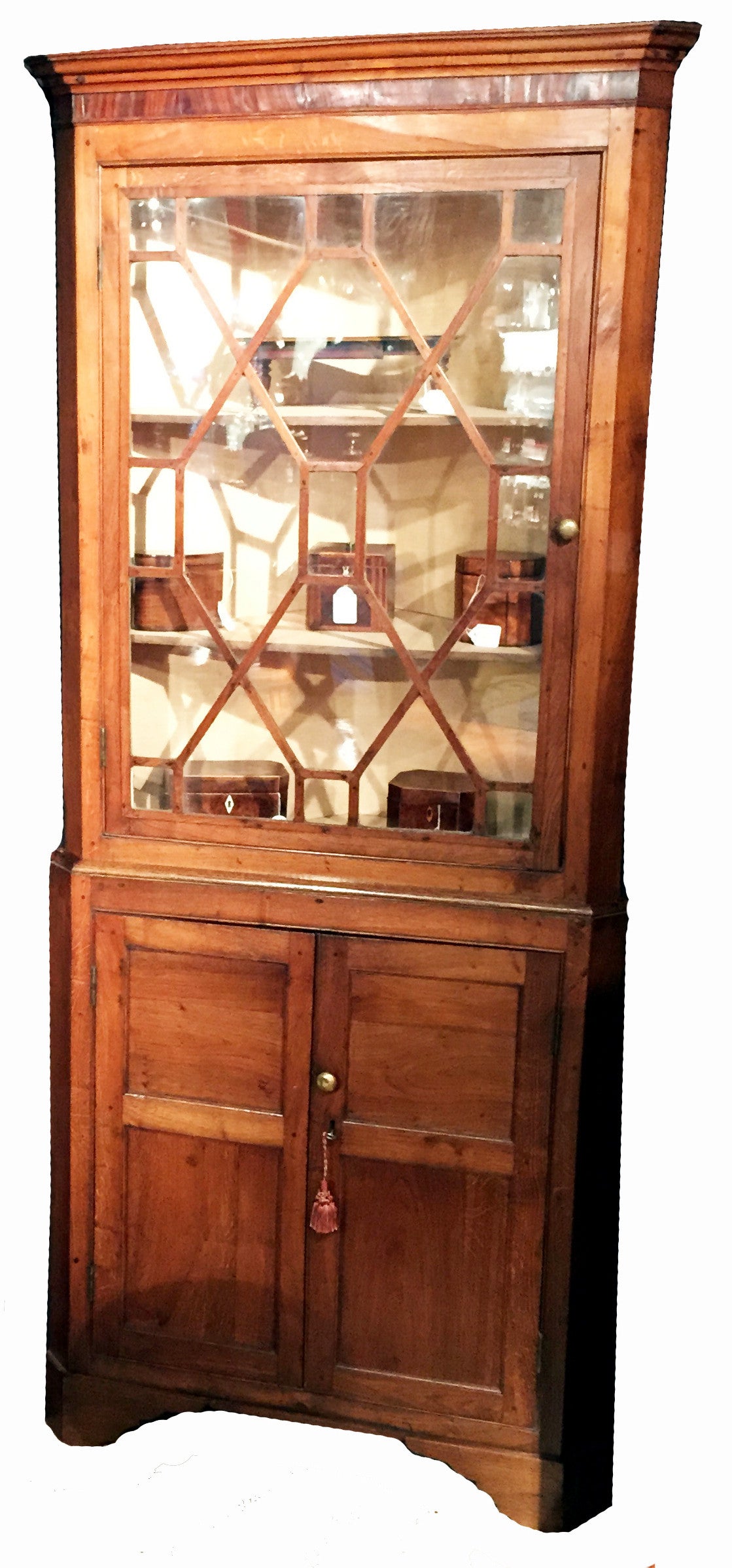 A delightful and charming early 19th century oak double cabinet
having attractive astragal glazed door to top and panelled double
doors to bottom raised on original shaped bracket feet.