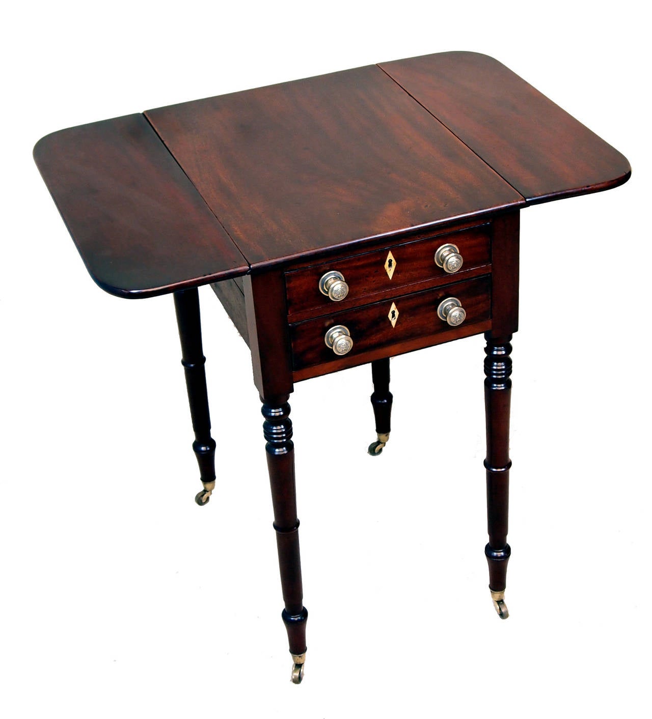 A Regency Mahogany Baby Pembroke Table Having Very 
Well Figured Top With Two Flaps Above Two Frieze Drawers 
Opposed By Two Dummy Drawers Raised On Elegant 
Turned Legs