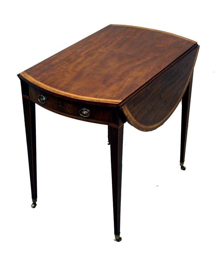 A Fine Late 18th Century Mahogany Pembroke Table
Having Well Figured And Double Banded Oval Top
Above One Frieze Drawer With Original Brass Handles
Standing On Elegant Square Tapered Legs