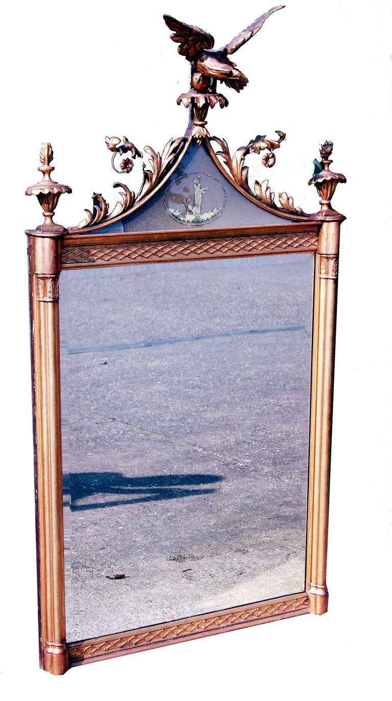 A fine Regency period gilt pier mirror having superbly carved eagle and foliage to surmount with inset églomisé panel flanked by two urns above replaced mirror plate and turned cluster columns.