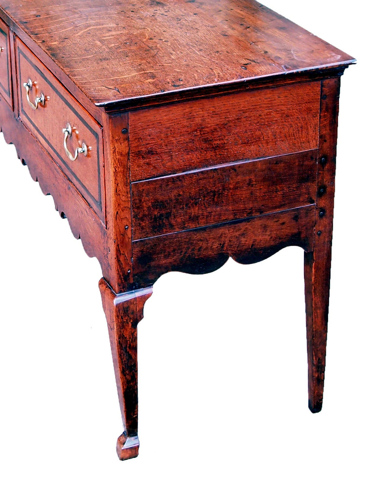 A George III Period Oak Dresser Having Three Drawers With Original 
Brass Swan Neck Handles To Elegant Shaped Frieze Raised On 
Unusual Square Sectioned Cabriole Legs