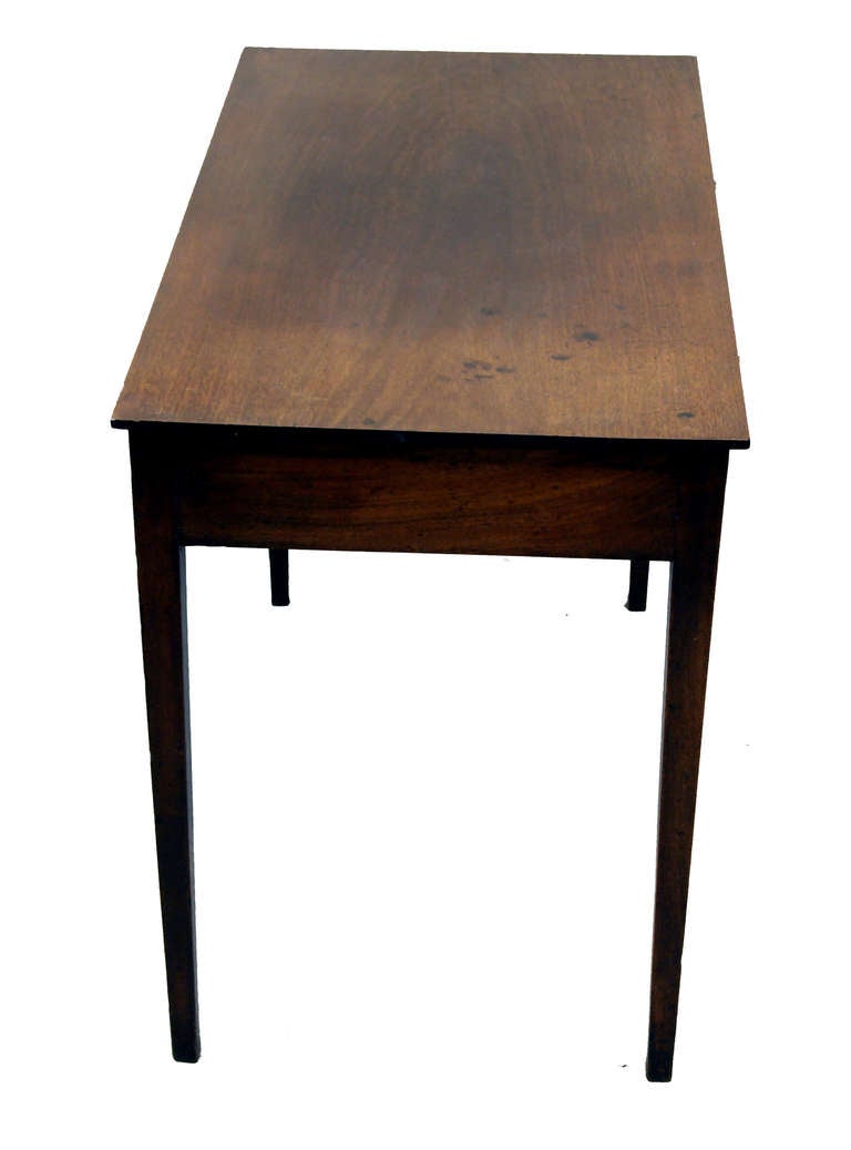 A good quality George III period mahogany side table having two drawers to frieze with original brass knobs standing on elegant square tapered legs.