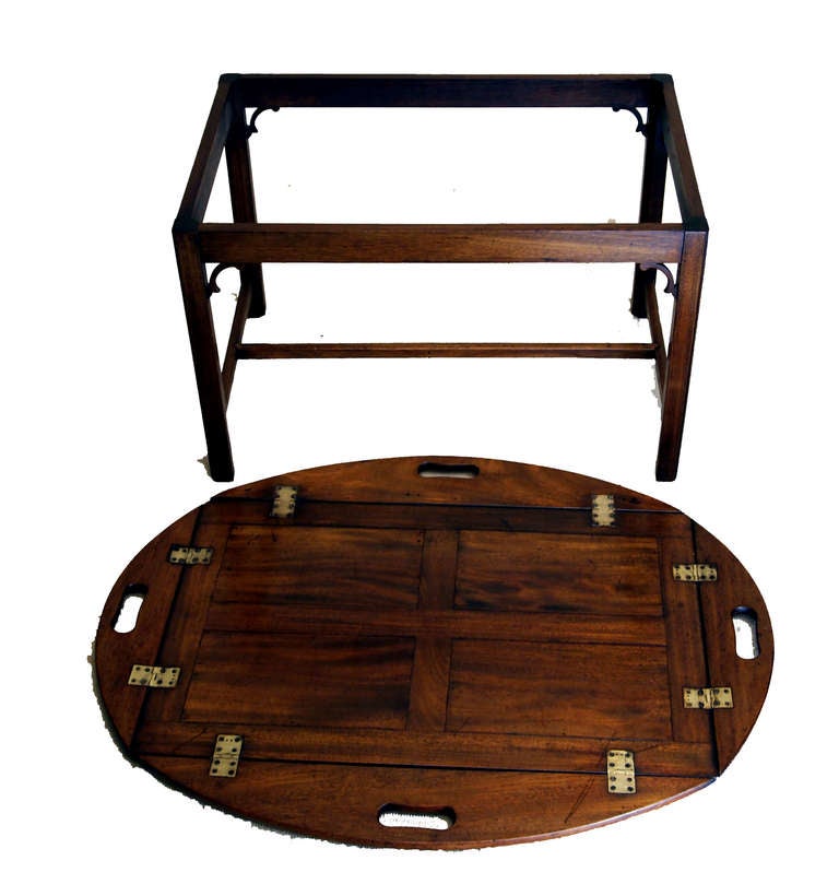 An Attractive Early 19th Century Mahogany Butlers Tray Of
Panelled Construction Having Shaped And Folding Sides With Original Brass Hinges Housed On Later Mahogany Square Leg
Stand.