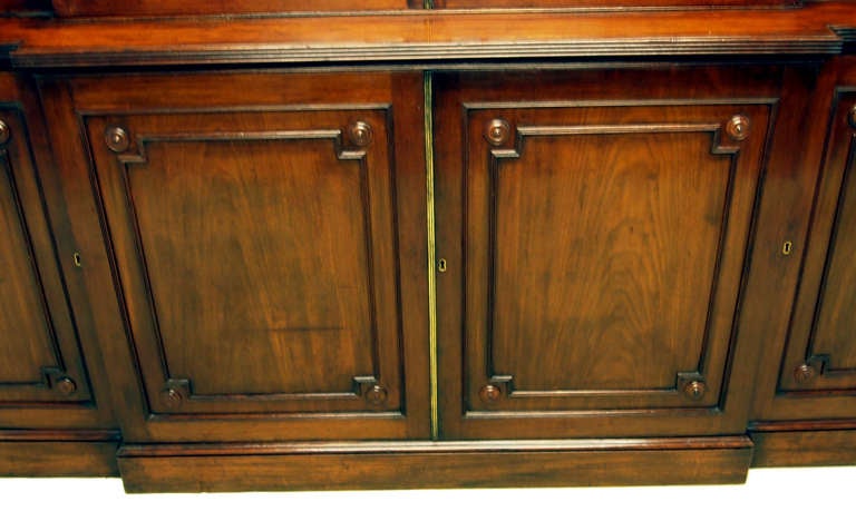 A Superb Quality Georgian Mahogany Breakfront Bookcase Having 
Four Astragal Glazed Doors Above Four Panelled Cupboard Doors 
With Applied Roundel & Reeded Decoration Throughout.