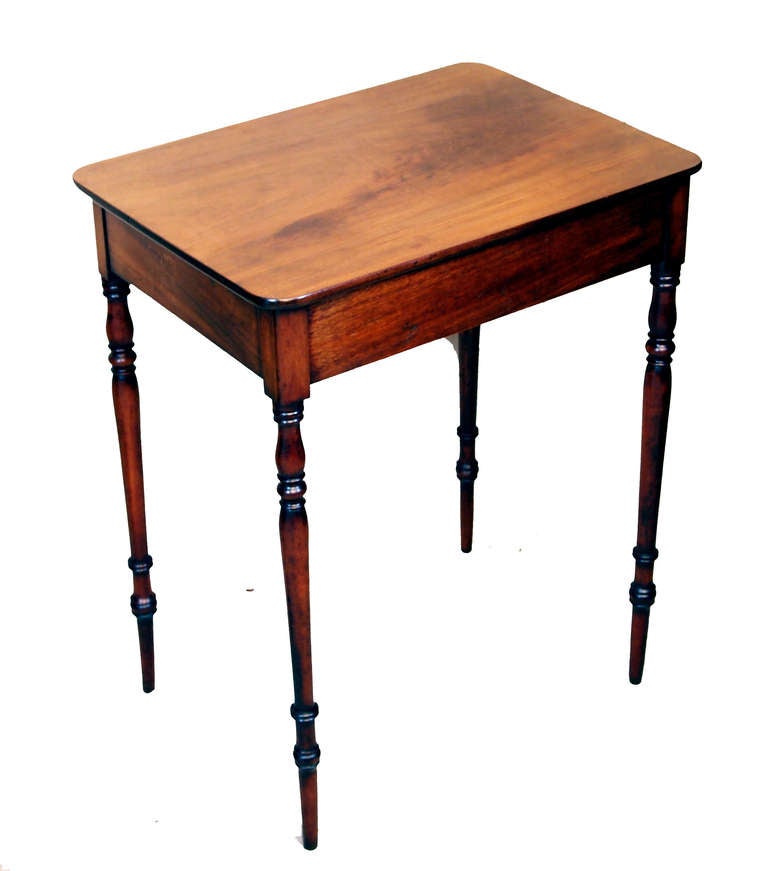 A very attractive regency period mahogany side table of
diminutive proportions having well figured top above one frieze
drawer with original turned wooden knobs and ebonized
decoration raised on elegant turned legs.