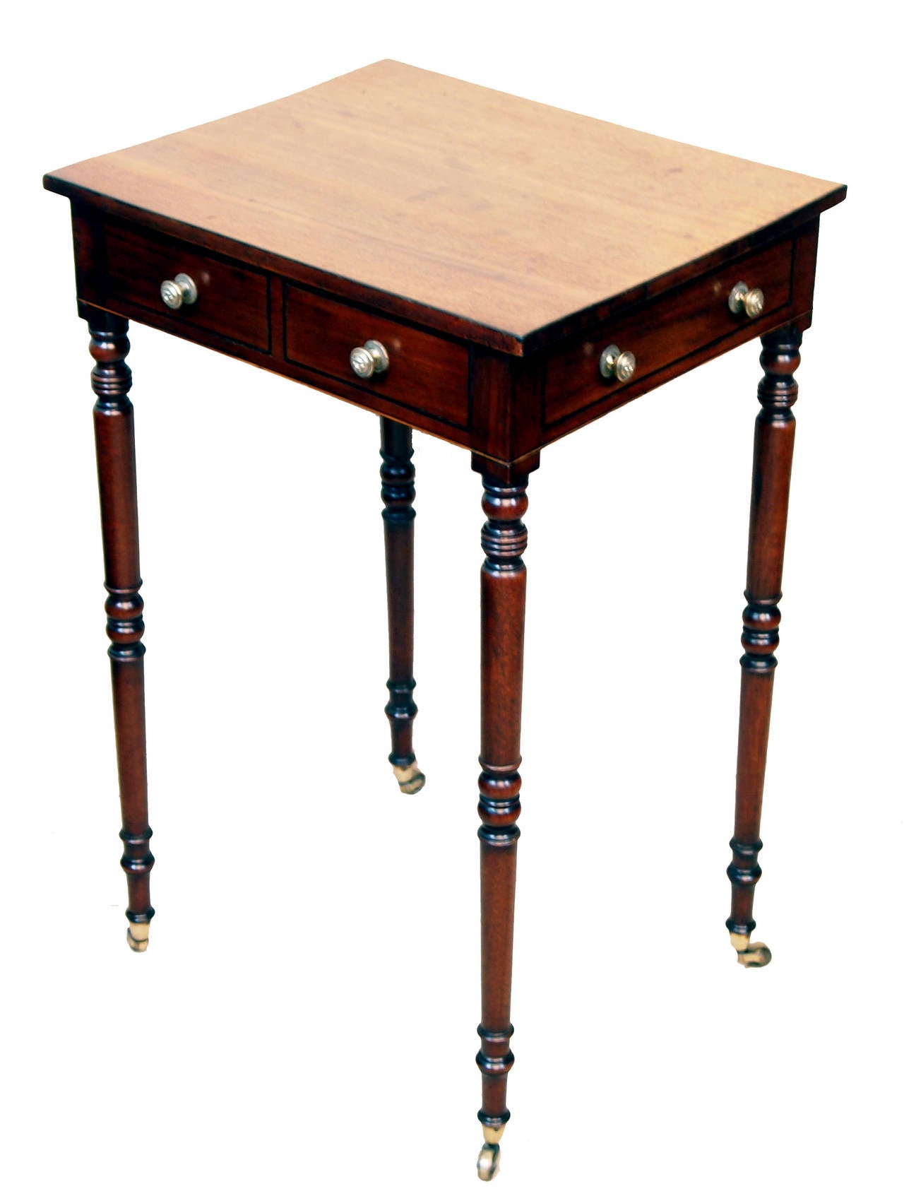 An Attractive George III Period Mahogany Lamp Table 
Of Diminutive Proportion Having Oblong Top With One 
Drawer And Three Dummy Drawers To Frieze Raised On 
Very Elegant Turned Legs And Brass Castors
