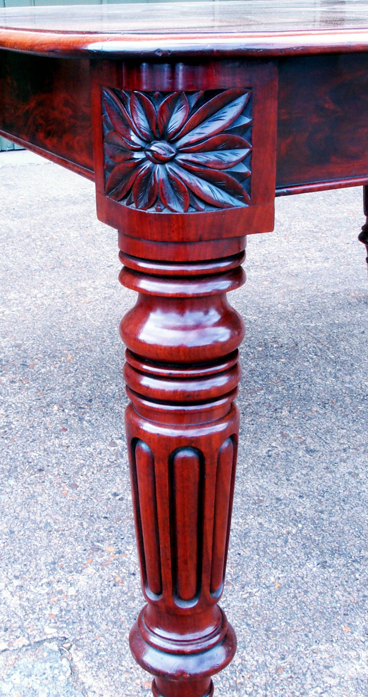 A fine quality late regency period mahogany extending dining
table retaining exceptional colour and patina to well figured top
with two original removable leaves raised on elegant turned and
fluted legs with superbly carved corner patrae &