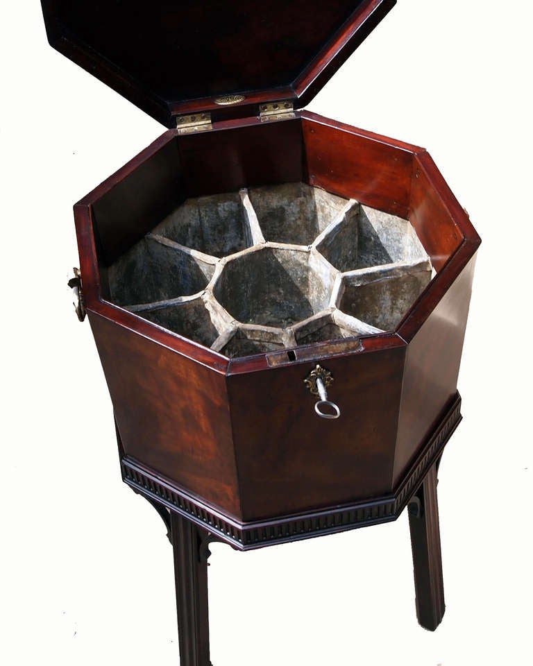 A Very Well Figured Octagonal George III 
Period Mahogany Wine Cooler Having Lift Up Lid 
To Reveal Original Lead Liner With Divisions 
Raised On Elegant Moulded Stand