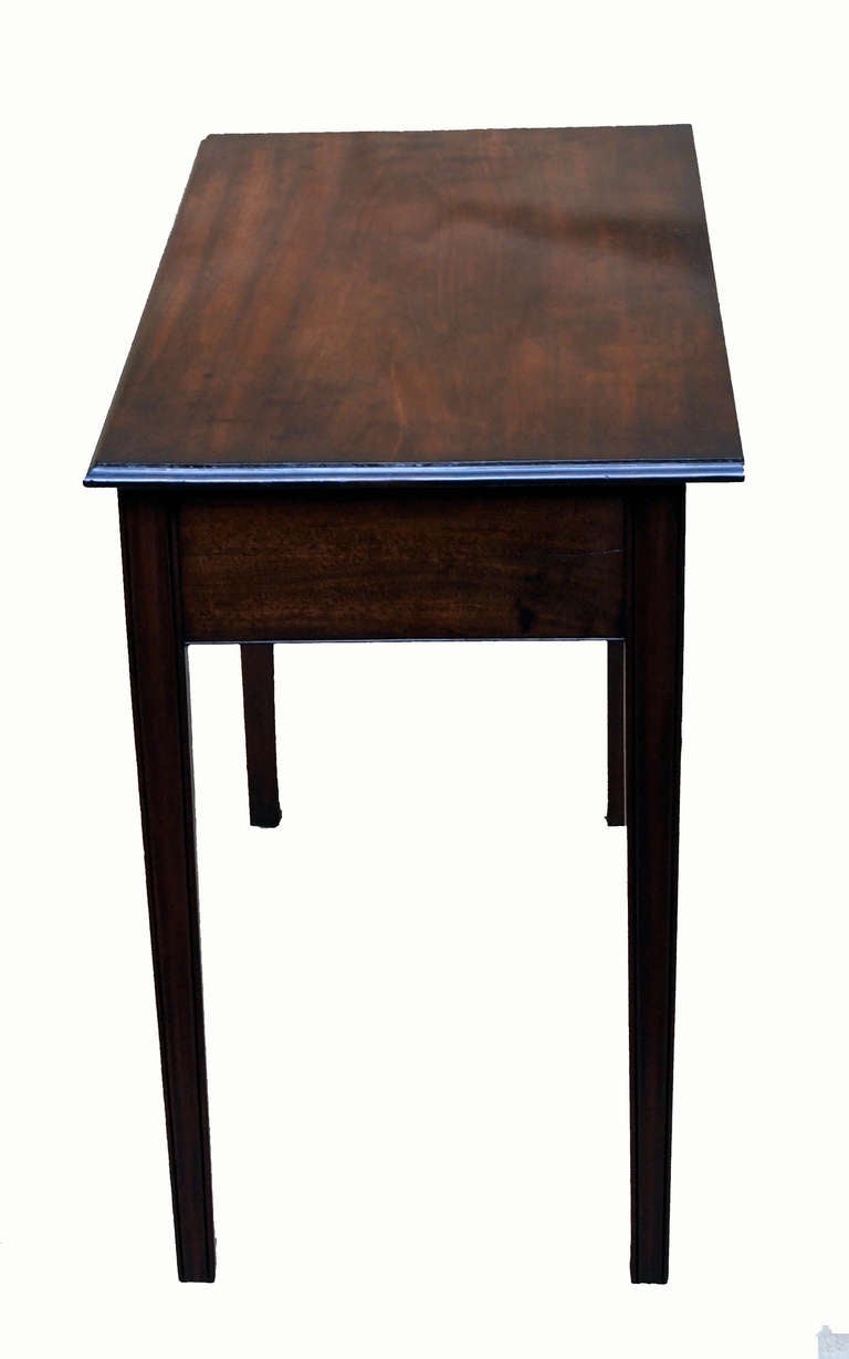 An 18th century mahogany side table of
excellent color and patina having one
drawer to frieze with original swan neck
handles standing on square moulded legs.