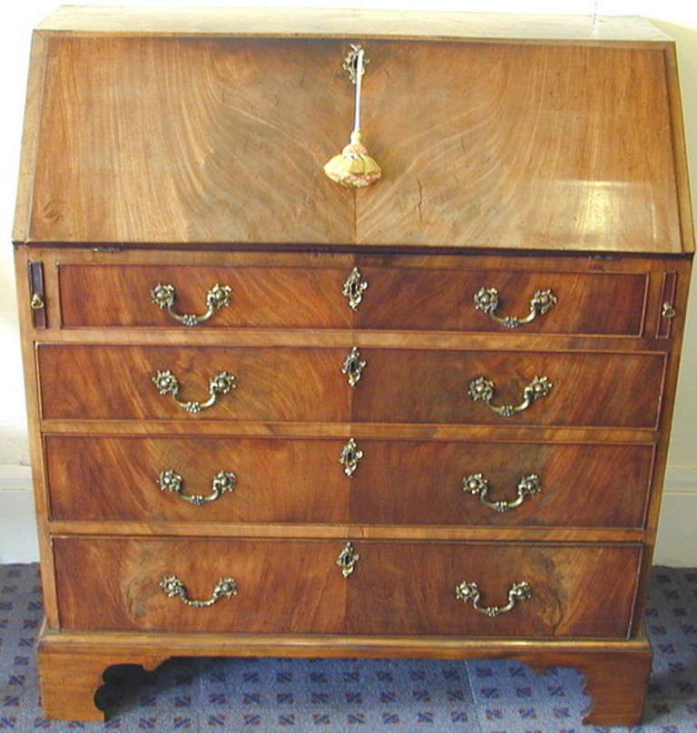 An 18th Century Georgian Mahogany Bureau Having 
Well Figured Fall Flap Above Four Long Drawers With
Original Water Gilt Handles Raised On Original Bracket 
Feet

(Typical of the late 18th century this bureau is a perfect
example of the effort that