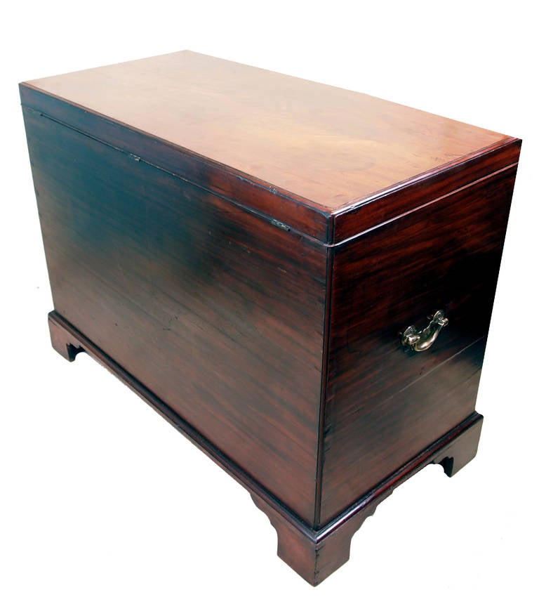 A delightful George II period mahogany silver chest having
superbly figured lift up lid with caddy moulded edge above two
long drawers raised on original bracket feet retaining original
brass wear throughout.