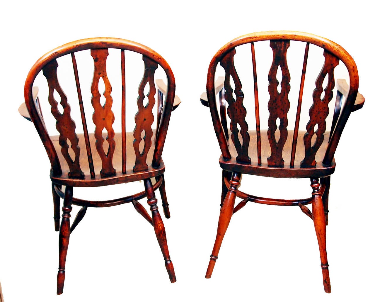 A Delightful Near Matching Pair of Early 19th Century Low Back 
Yew Wood Windsor Armchairs Having Three Pierced And Shaped 
Splats With Central Set Roundels And Alternating Spindles Above 
Well Figured Arms And Shaped Seats Raised On Elegant