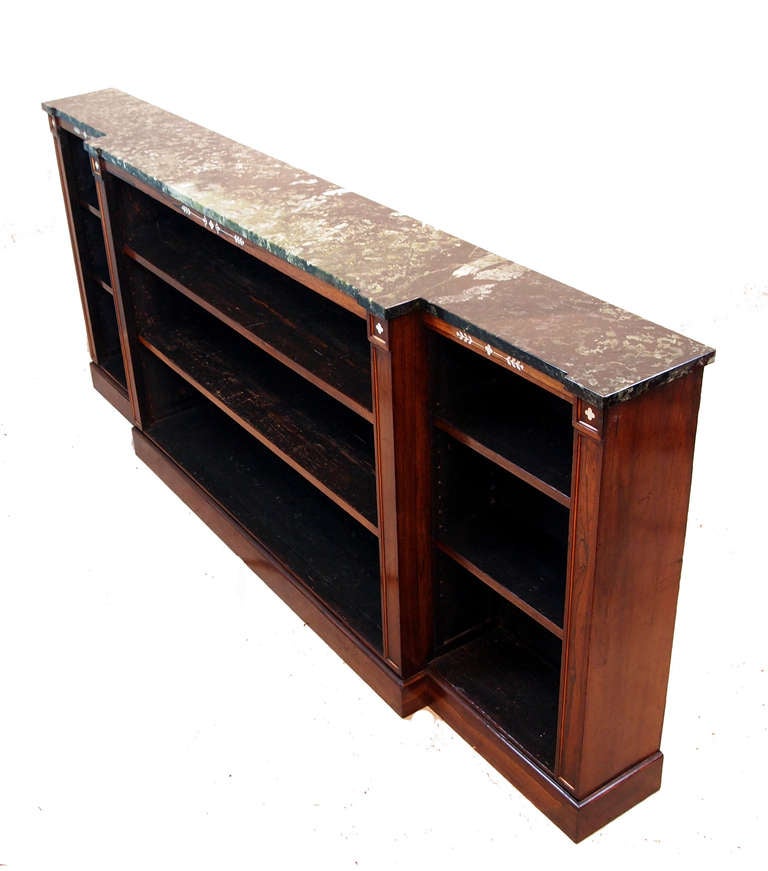 A Stunning Quality Regency Period Rosewood Breakfront Dwarf 
Open Bookcase Having Delightful Replaced Marble Top Above 
Ivory Inlaid And Boxwood Moulded Decoration To Frieze And 
Stiles Raised On Original Plinth Base