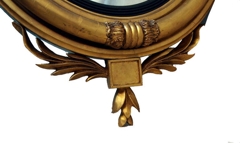 A very attractive regency period gilt convex mirror having well
carved ebonized eagle and foliate ribbon carving to top and half
turned column border with tablet and foliage carving to bottom.