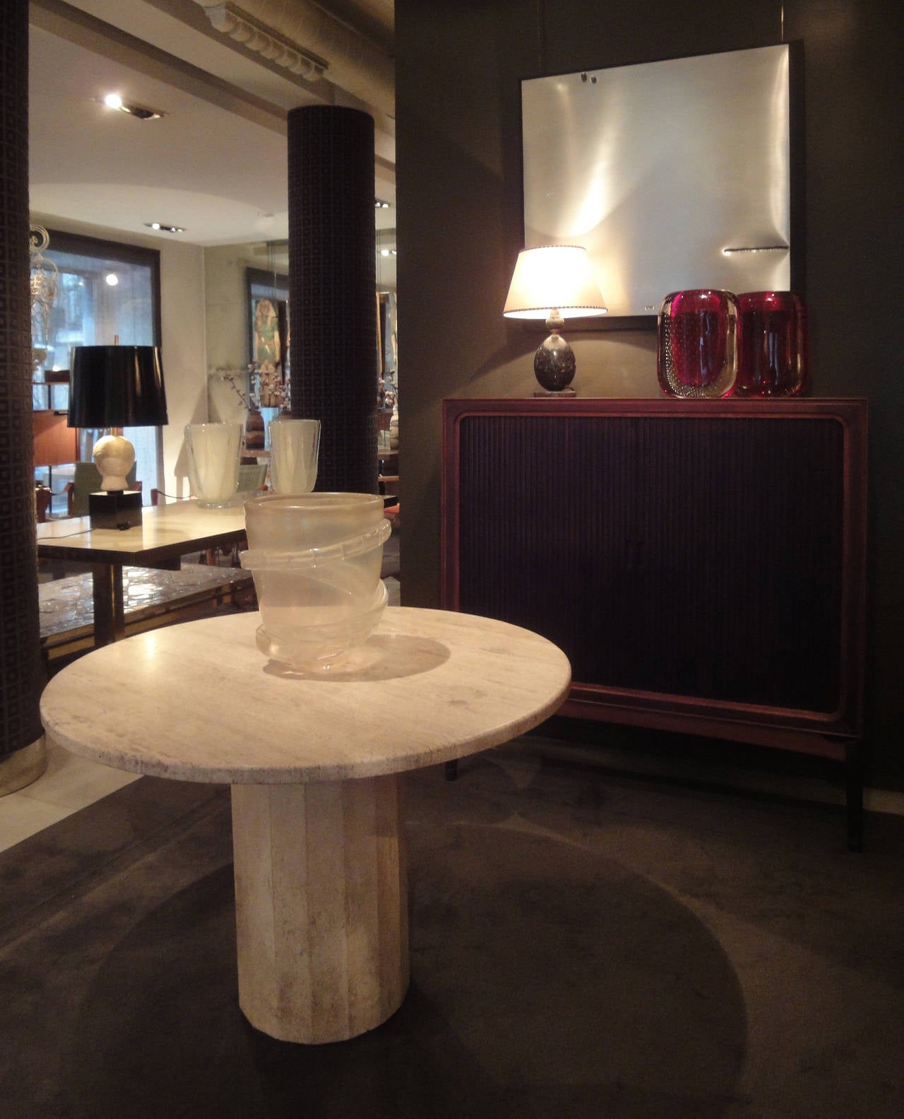 A rosewood, mahogany and birch-wood cabinet-on-stand with sliding doors.