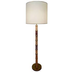 A brass and rattan floor lamp