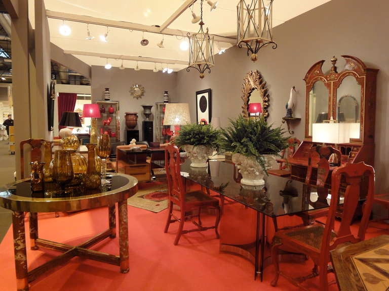A set of ten Queen Anne style dining-chairs decorated with chinoiseries on a red-lacquered ground.