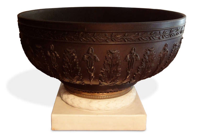 A Wedgwood Basalt-ware bowl mounted on a biscuit and bronze base.