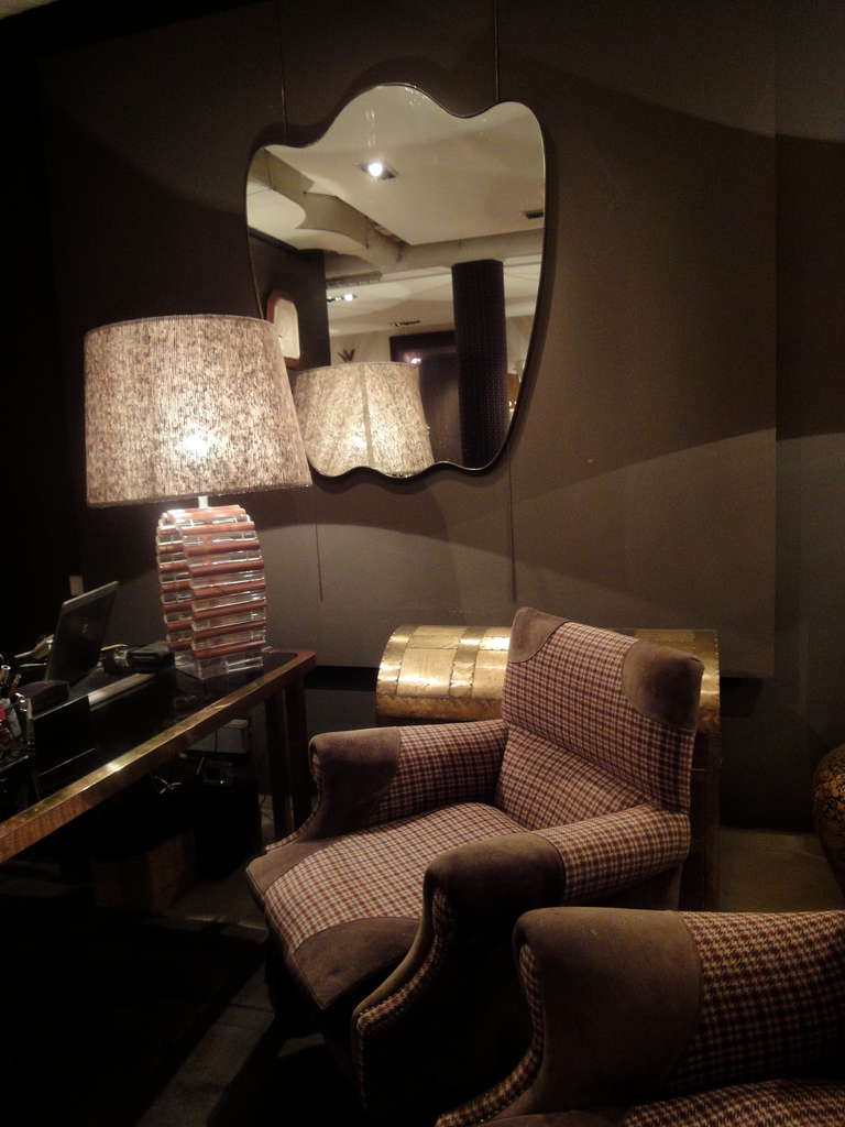 A large curvy mirror with a simple copper frame by Paolo Buffa for Gio Ponti.