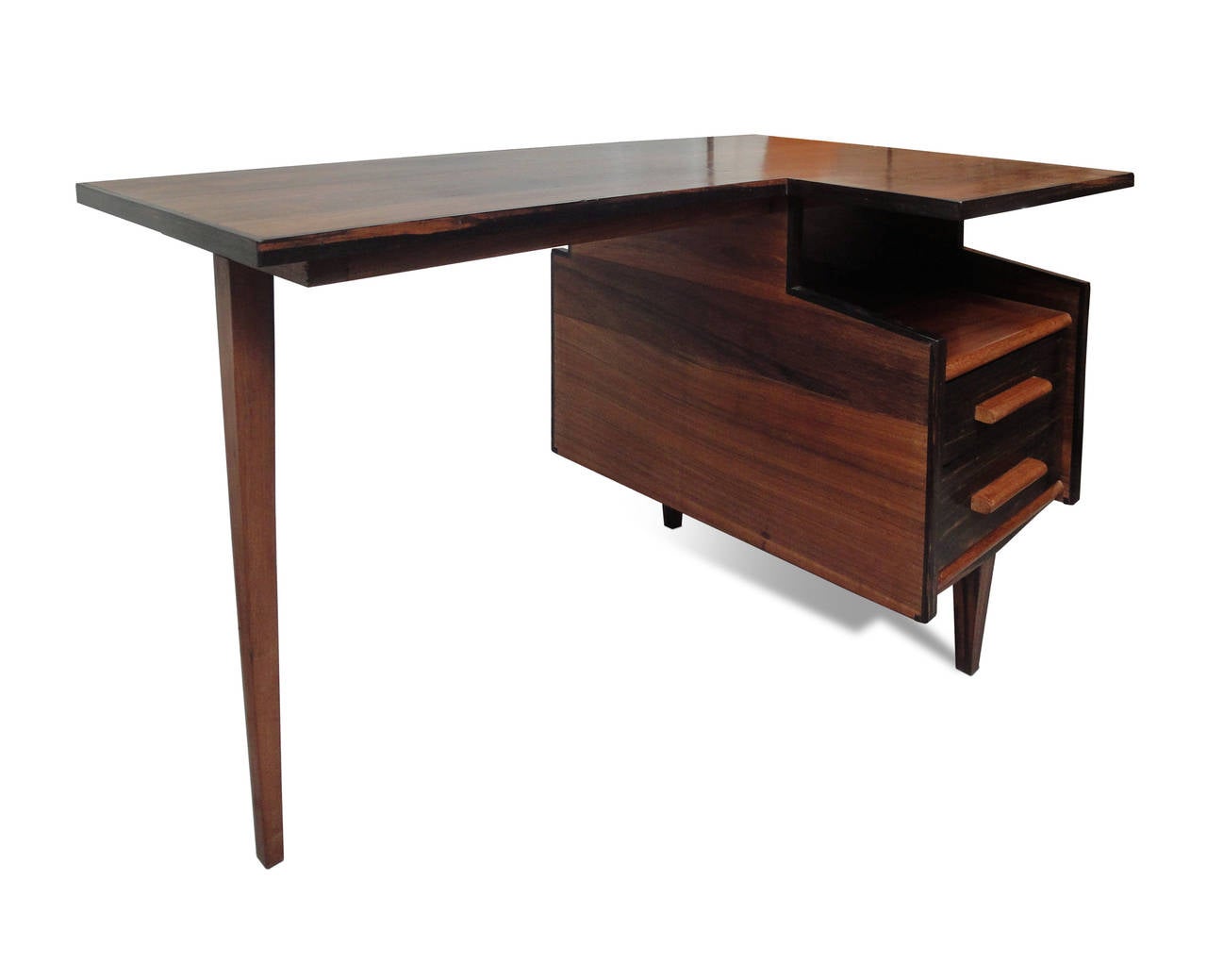 An asymetrically-shaped rosewood desk.