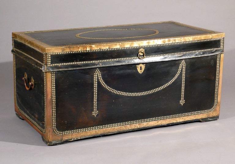 A rare set of three leather and camphor wood trunks. all three with brass handles, c.1800, England