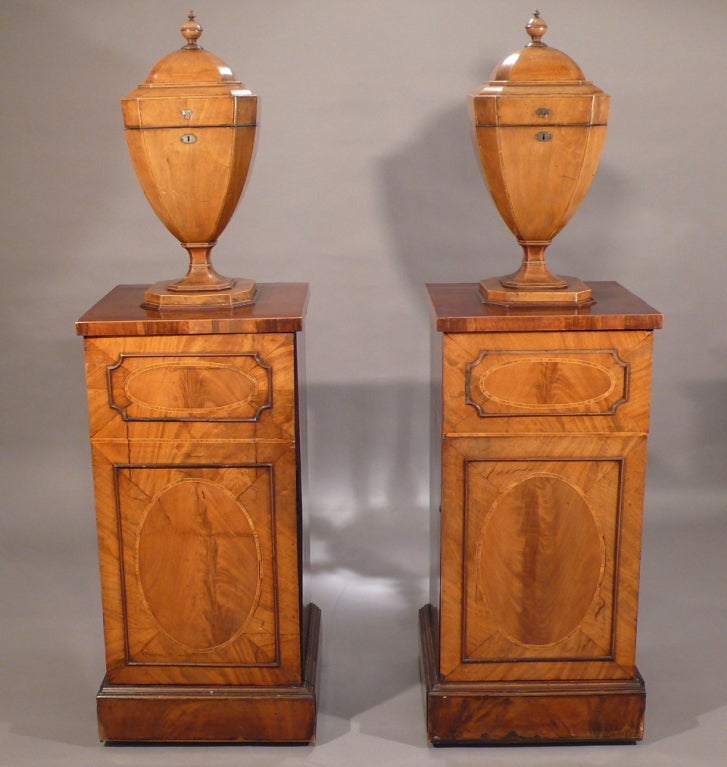 A Pair of George III mahogany Knife Urns with cupboard pedestals, marquetry, Last quarter of the 18th century.
Provenance: Australian Embassy in Paris