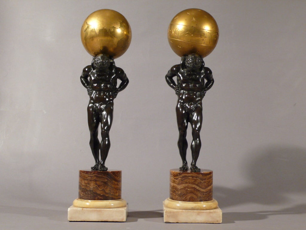 A great pair of Bronze Atlas with gilt bronze celestial and terrestrial globes, alabaster fiorito and white Carrara marble bases, circa 1840, France.