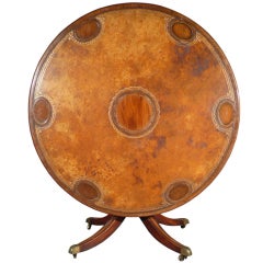 A George III leather and mahogany games table