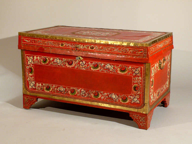An export Canton red leather trunk in camphor wood, decorated with flowers, circa 1820, China<br />
<br />
The legs have been added later