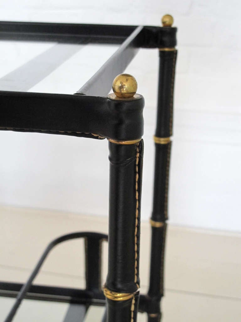 Bar cart in stitched leather and brass. Designed by Jacques Adnet, circa 1960, France.