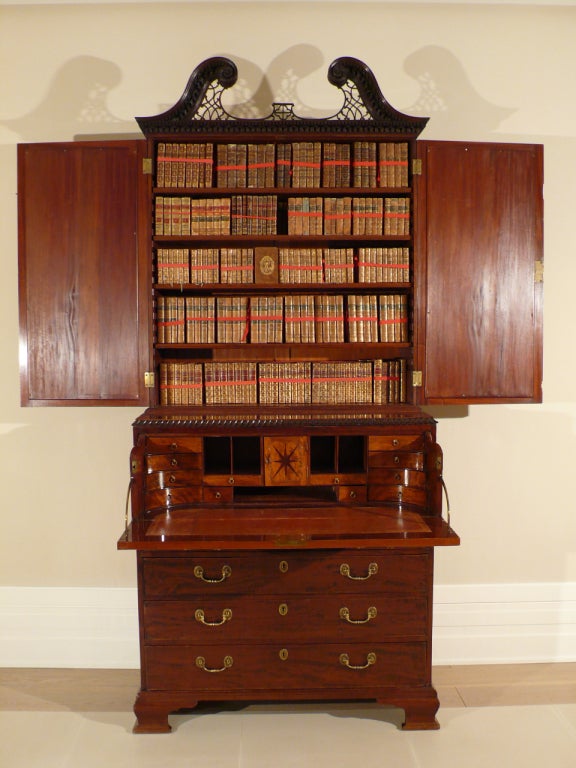 A Mahogany bookcase and secretaire with original mirrored doors and bronze handles circa 1760 England. Attributed to Giles Grenday