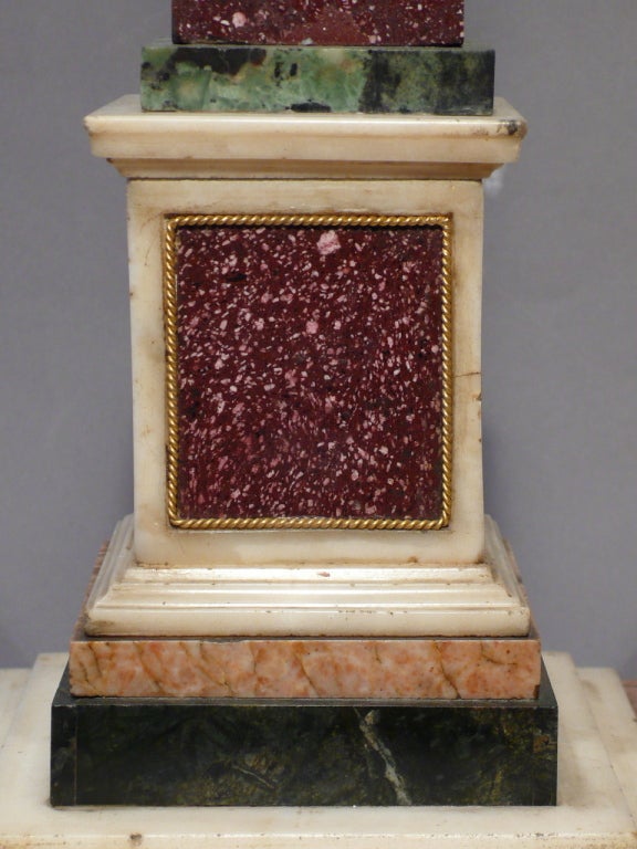A Grand Tour red royal porphyry obelisk, Verde antico marble, Sienna Marble paw feet