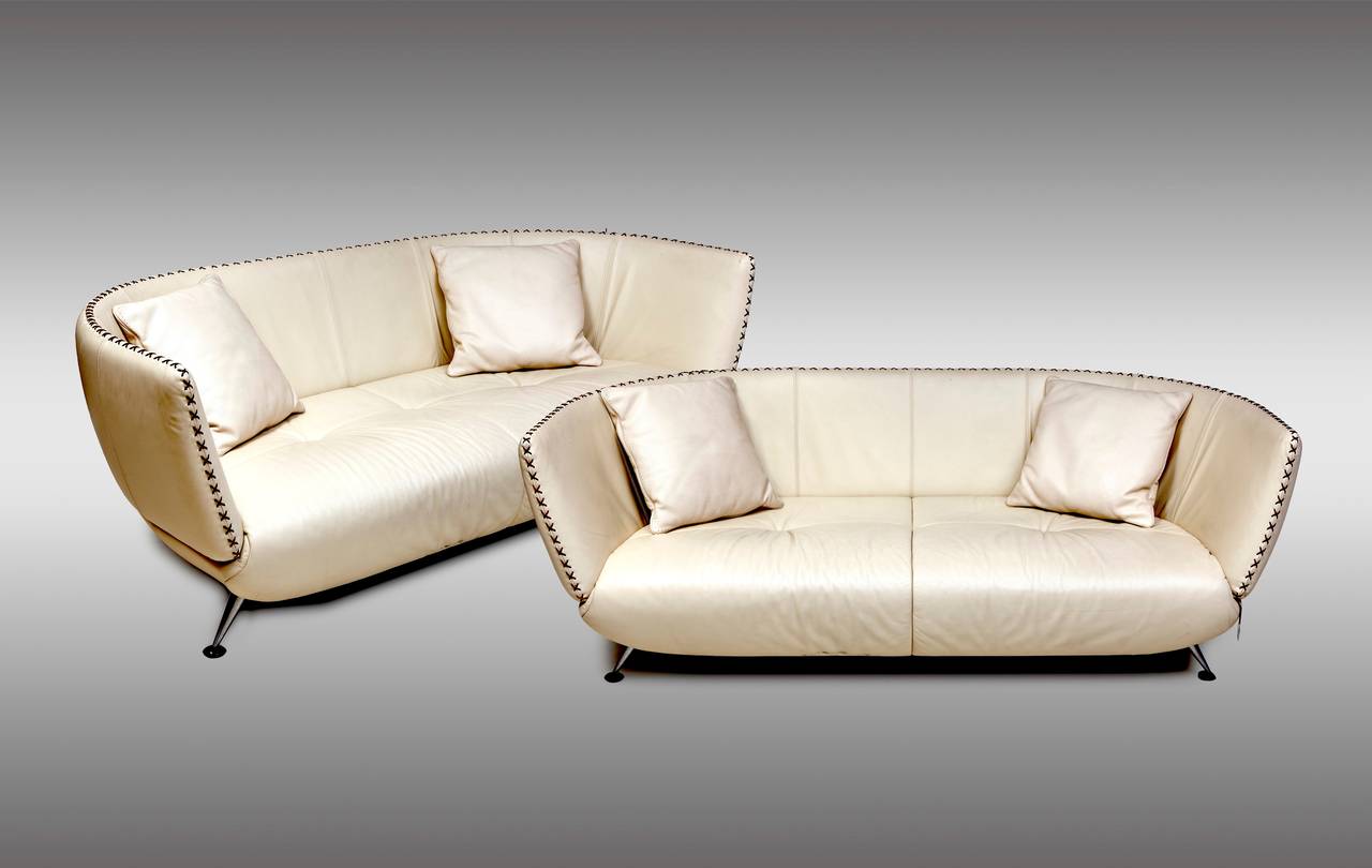Two ivory leather De Sede sofas. With original suede cushions, 1980s (Can be sold separately).