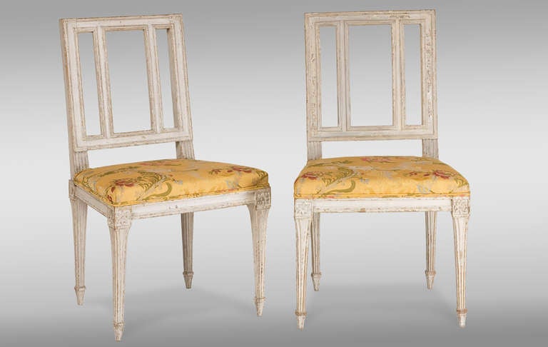 Two French Louis XVI Period painted Chairs.
With fluted square legs. 
Reupholstered embroidered yellow fabric. 
Nice patina of age.