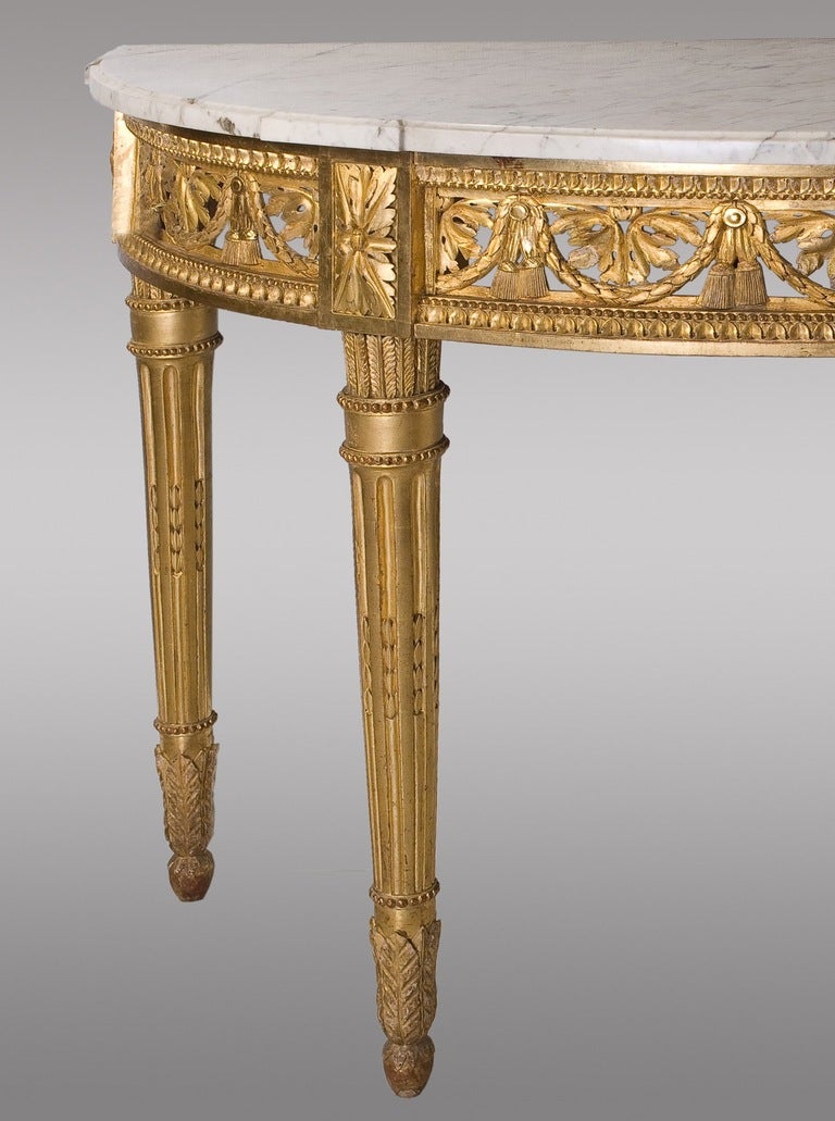 Magnificent carved and gilded Louis XVI Period Console.
Topped with white veined marble.
Carved with leaf motifs and garlands.
Shaped legs quiver of arrows.