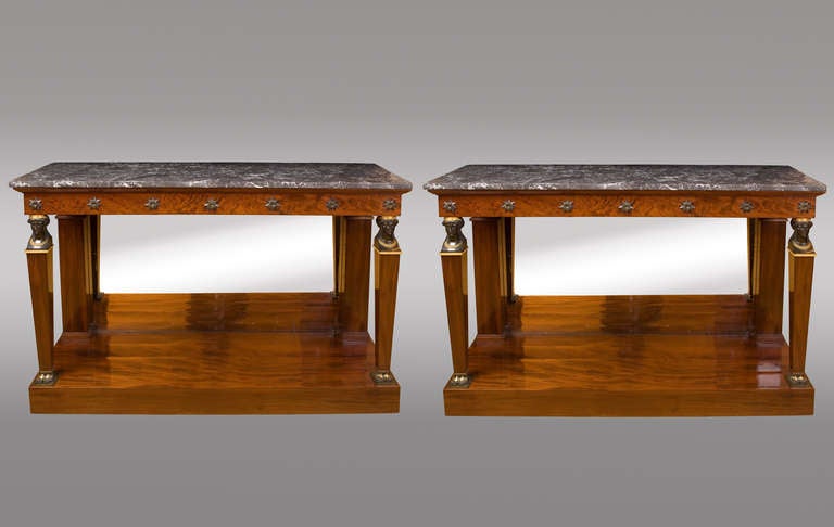 In mahogany and back mirrored. 
Gilt and patined bronze, with gray marble tops.