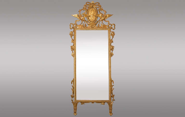 Tuscany gilded wood mirror 
Topped with fantastic birds surrounding medallion.