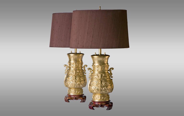 Pair of lamps in gilded bronze and wood bases, with shades in brown silk. 70`s