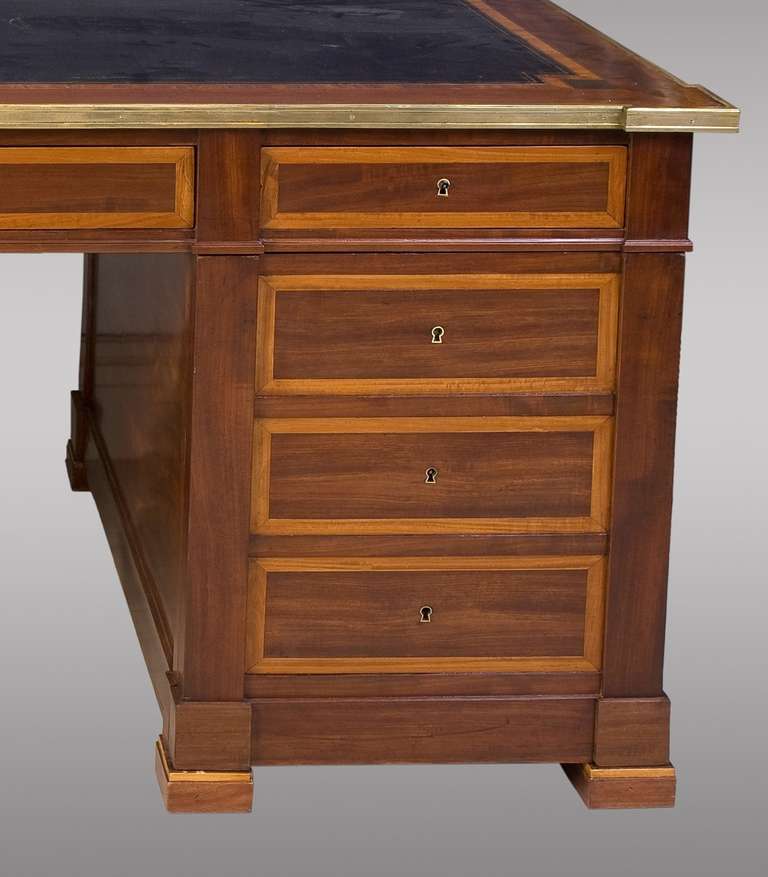 French pedestal desk in mahogany and crossbanded sycomore. With six drawers and simulated door in the rigth side. Two pull out side shelves. Beautiful construction and finish. 19th. Century.