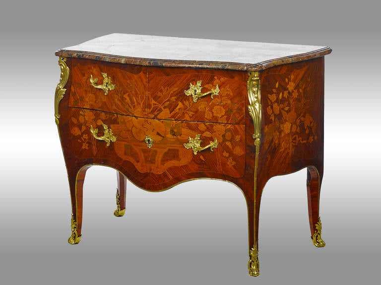 A superb marquetry Louis XV commode. Stamped "R. Dubois" (Maitre in 1755, son of Jacques Dubois) with three drawers to the front, veneered in satin, rosewood and amaranth. Motif of musical instruments to the front and bouquet on both