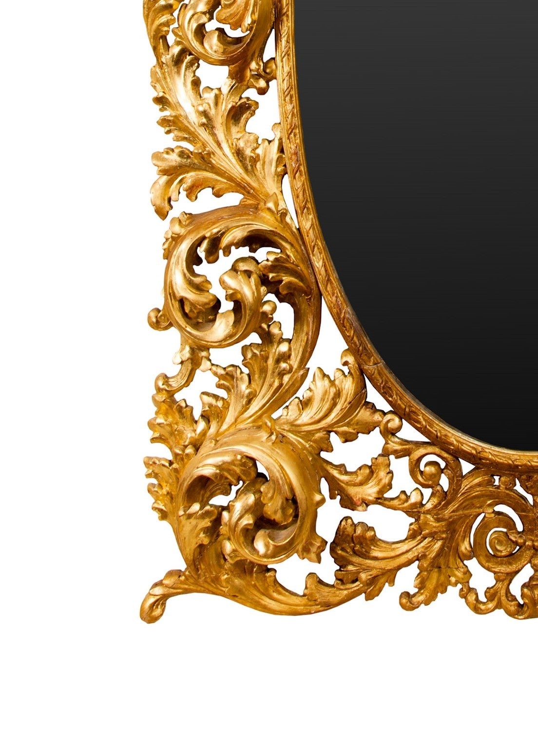 Large Rococo style giltwood gesso mirror. Richly decorated with scrolled acanthus leaves.