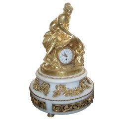 A gilt bronze and marble figural clock in the Louis XVI style