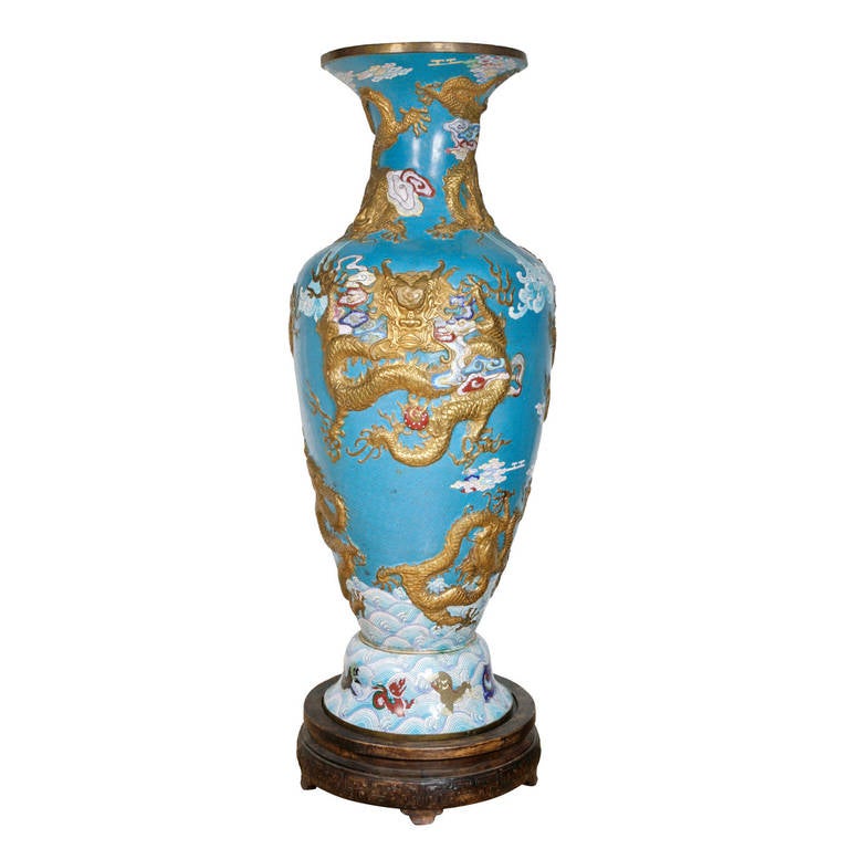 With gilt decorations of dragons on a light blue enamel ground with intricate designs, set on a fitted wooden base.