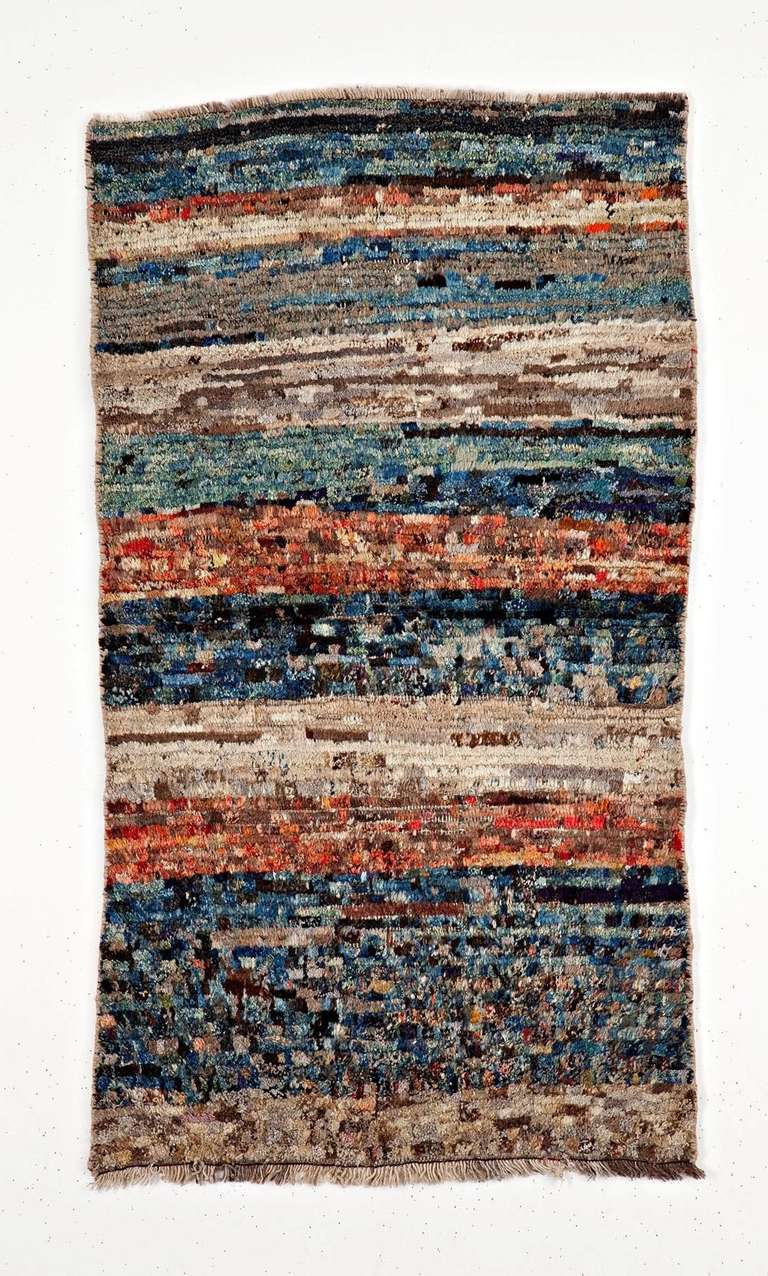 Gabbeh - a fascinating Persian  rural rug.
Missoni style with a polychromatic and very abstract open field.
No design but some very traditional lazy lines. 
Simple, fresh and magic with a marvelous colored 
