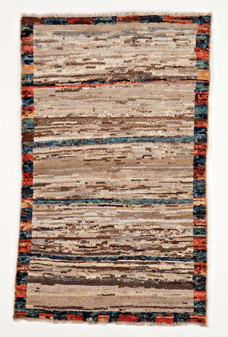 Gabbeh - a fascinating Persian  rural rug.
Missoni style with a polychromatic and very abstract open field within a frame checkerboard. No design but some very traditional lazy lines. No design but some very traditional lazy lines.
Simple, fresh