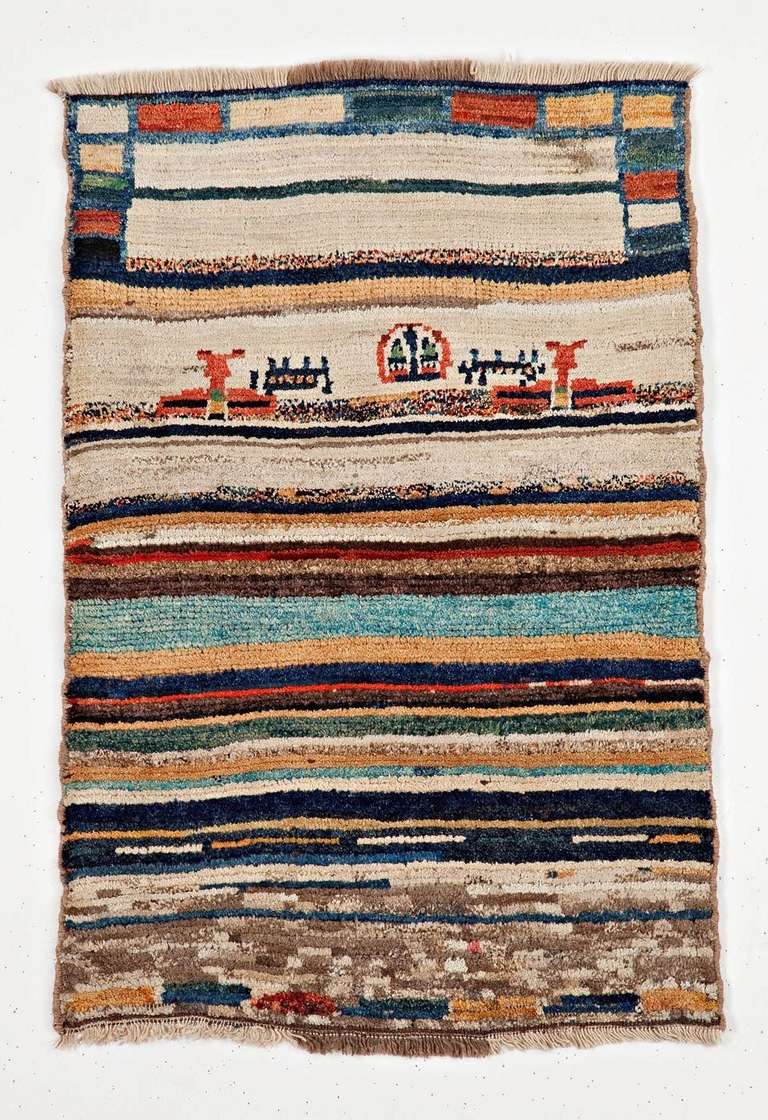 This unique and eye-catching Gabbeh rug is made with extra high pile and extra fine wool yarns - very bright and vivid.With a multicolored stripes and abraches foe the field, this rug also shows some emblematic characters found in early Gabbeh rugs